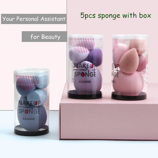 Three clear acrylic containers filled with purple, blue, and pink teardrop makeup sponges.
