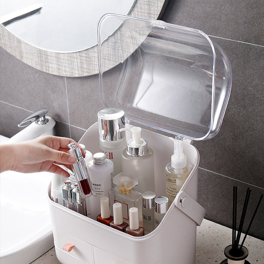 White plastic cosmetic organizer with clear lid containing skincare bottles and lotions.
