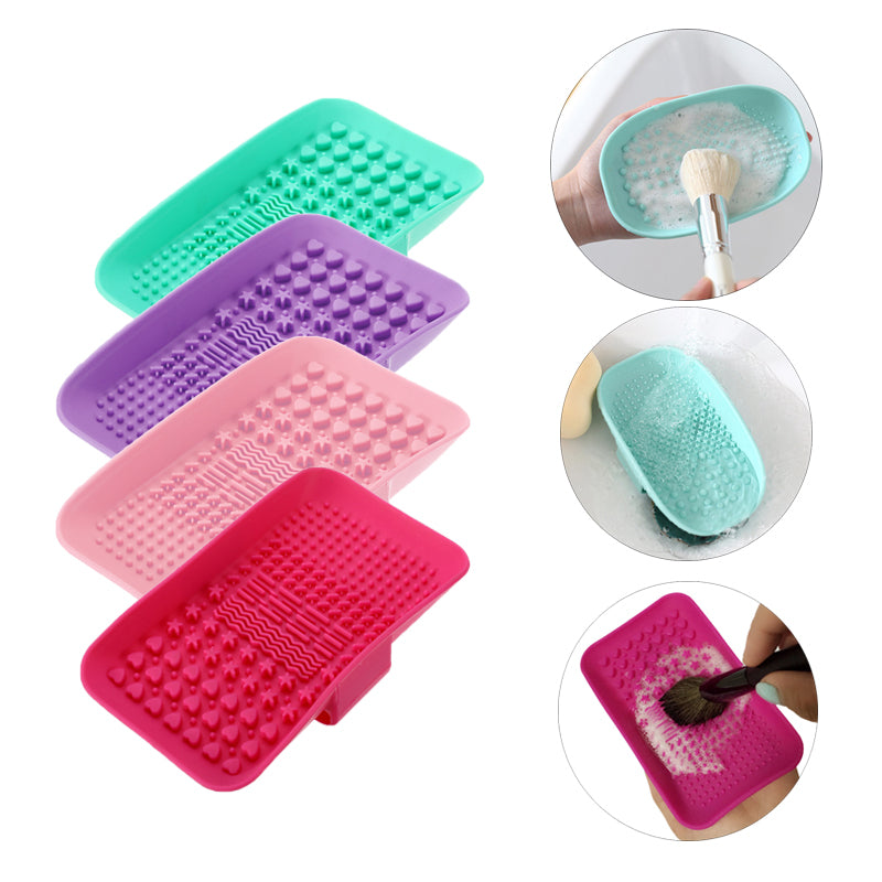 Colorful silicone makeup brush cleaning mats in teal, purple, pink, and red.