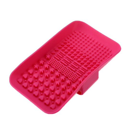 Pink silicone textured foot scrubber with heart, star, and wave patterns