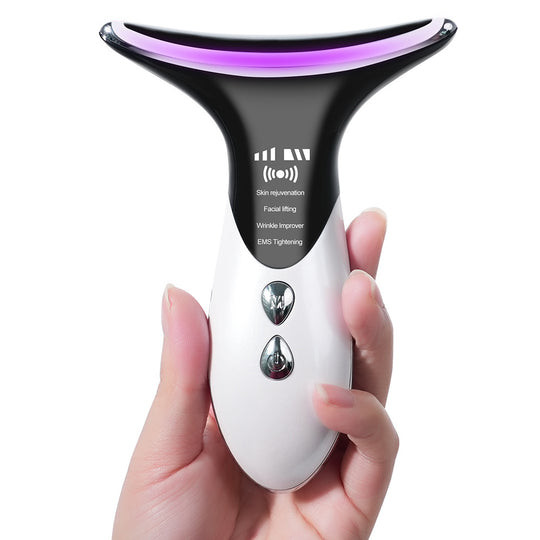 Hand holding a white facial rejuvenation device with purple LED light for skin tightening.
