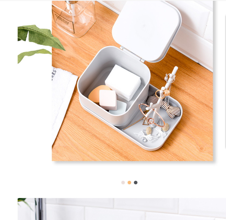 Open grey jewelry and cosmetic organizer box on a wooden surface with accessories inside.