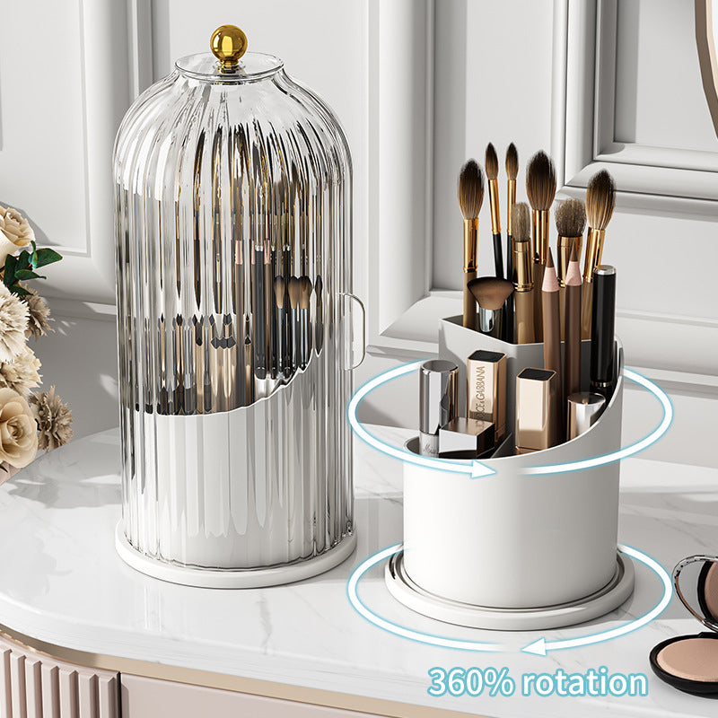 White 360 degree rotating makeup brush holder and glass dome cosmetic organizer on marble vanity.