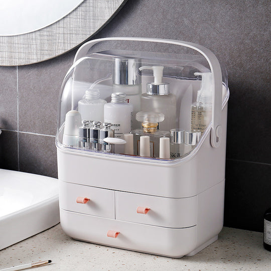 White plastic skincare organizer with transparent lid and small storage drawers on a bathroom counter