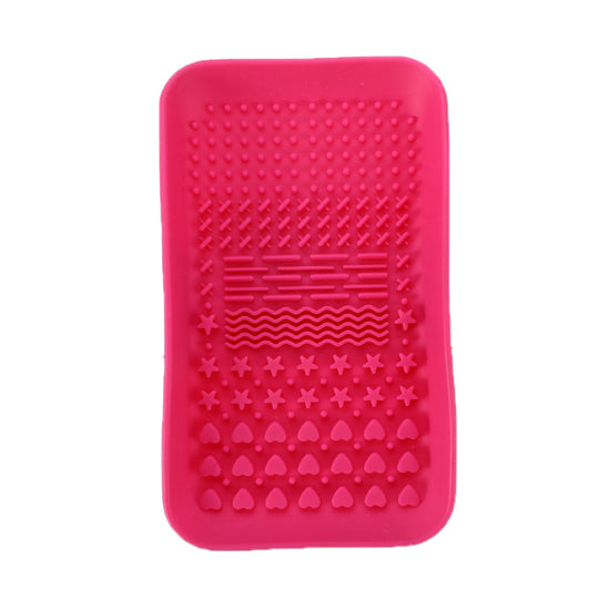Bright pink silicone textured massage tool with various embossed patterns