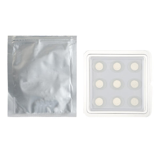 Silver foil packaging next to a white tray with nine circular skincare patches.