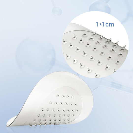 Close-up of a curved stainless steel foot scrubber with small massage spikes.