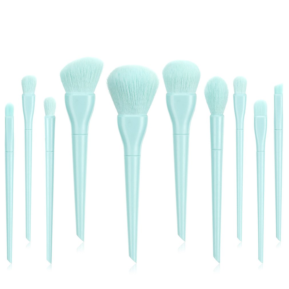 Set of light blue makeup brushes with soft synthetic bristles on a white background