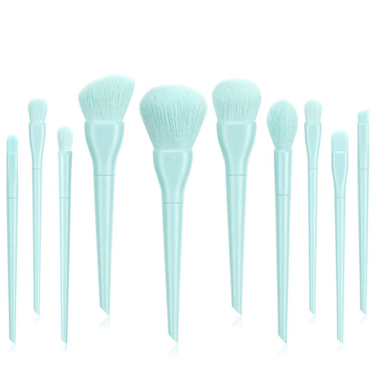 Set of light blue makeup brushes with soft synthetic bristles on a white background